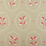 Detail of fabric in a repeating leaf print in red and cream on a light brown field.