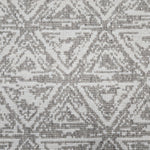 Broadloom carpet sample in a textural stacked triangle pattern in white and grey.