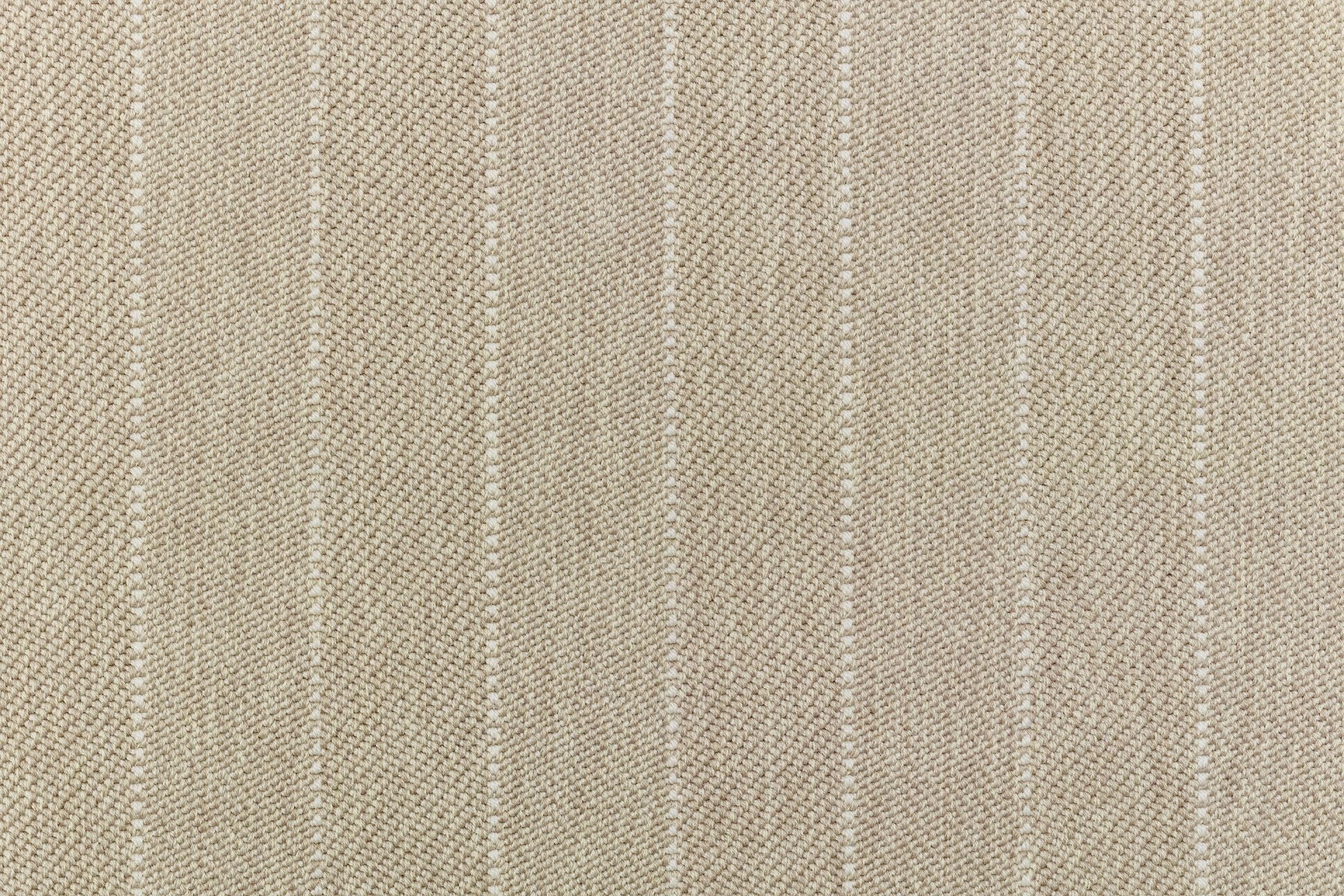 Broadloom carpet in a herringbone stripe pattern in beige.