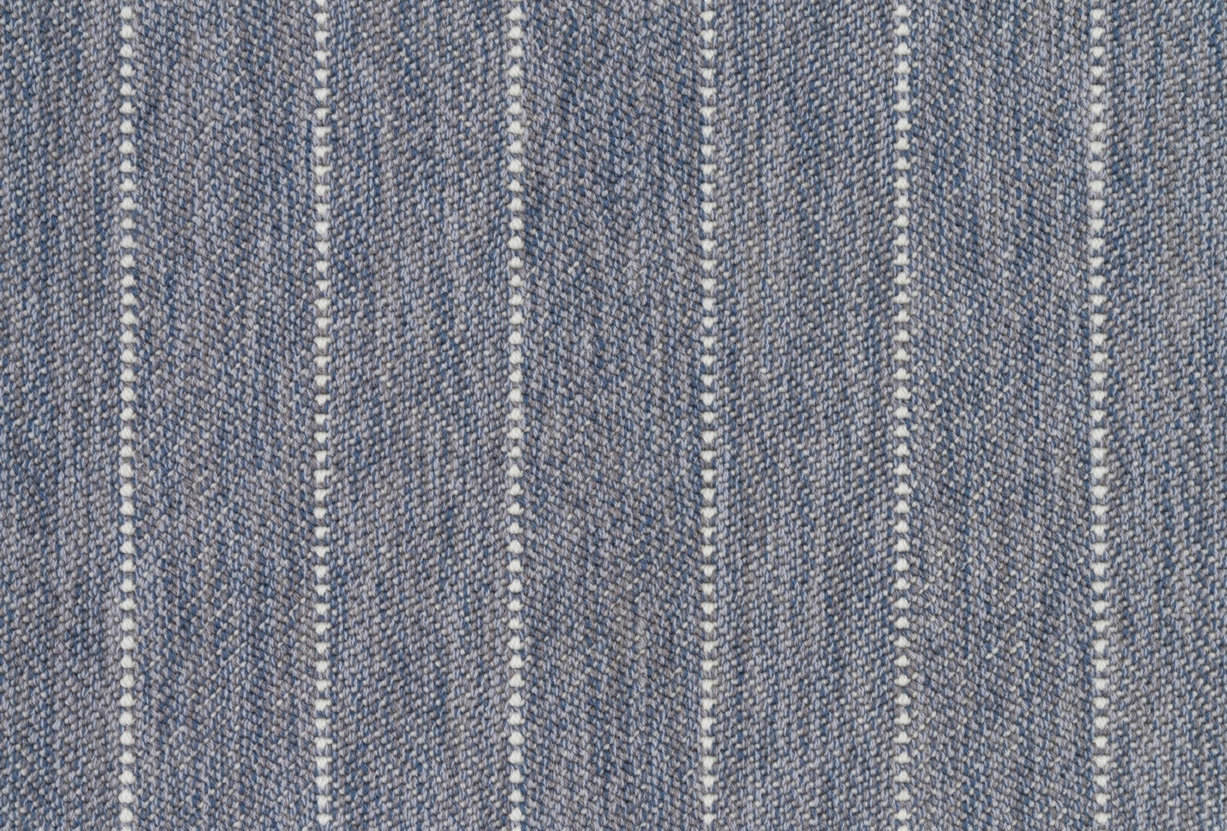 Broadloom carpet in a herringbone stripe pattern in slate blue.