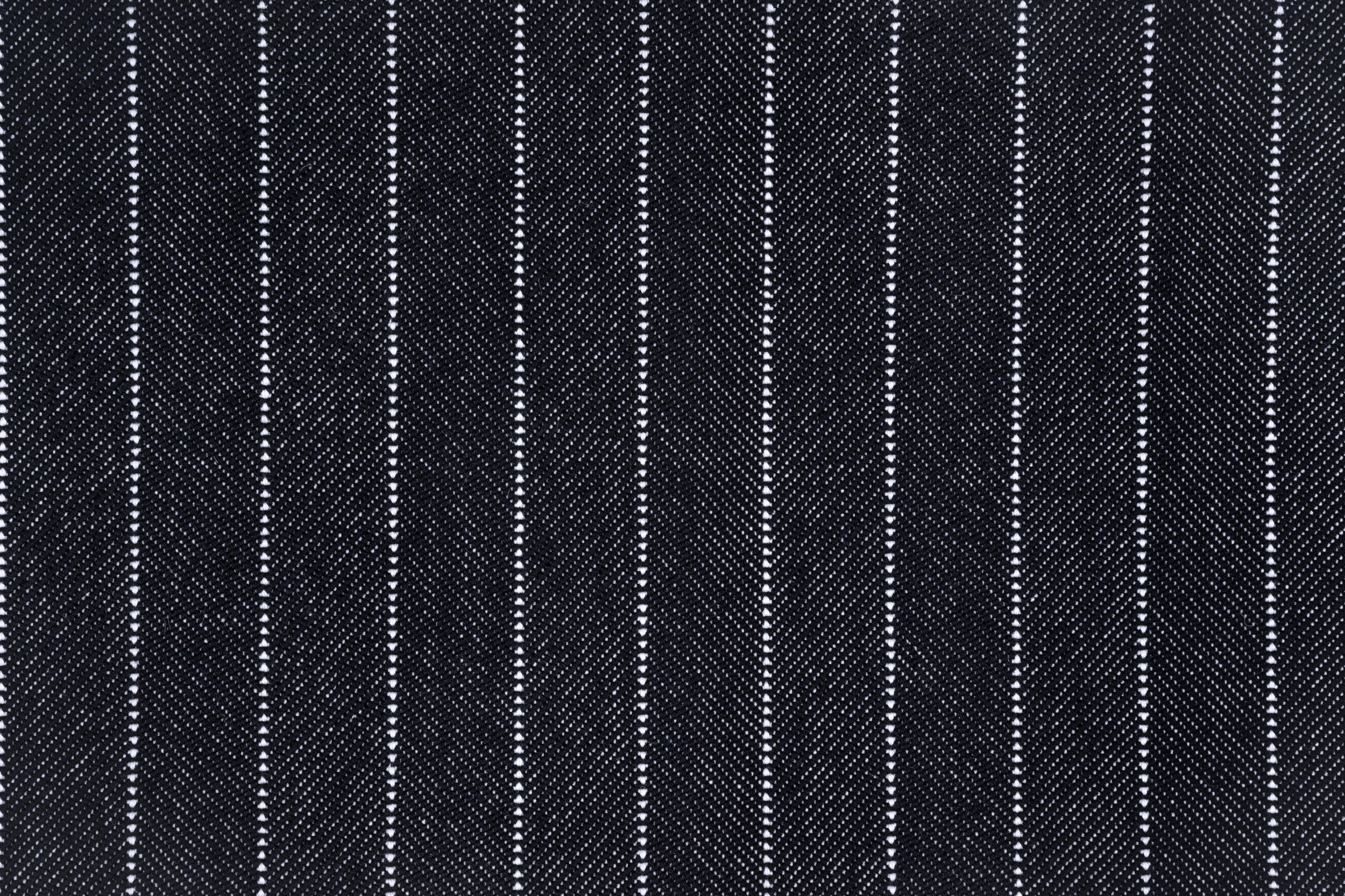 Broadloom carpet in a herringbone stripe pattern in black and white. 