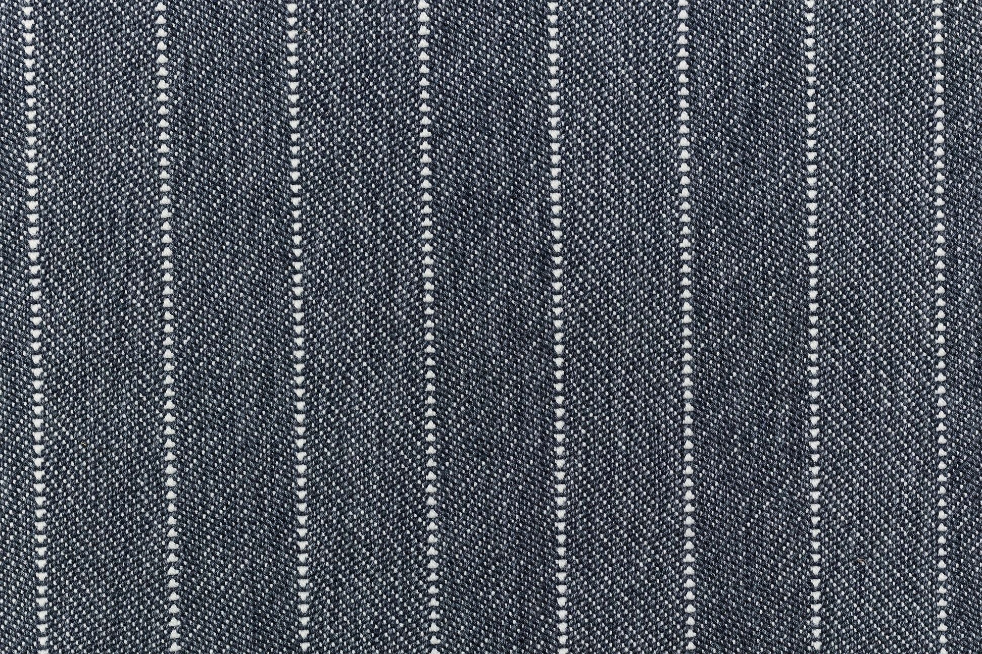 Broadloom carpet in a herringbone stripe pattern in navy blue. 