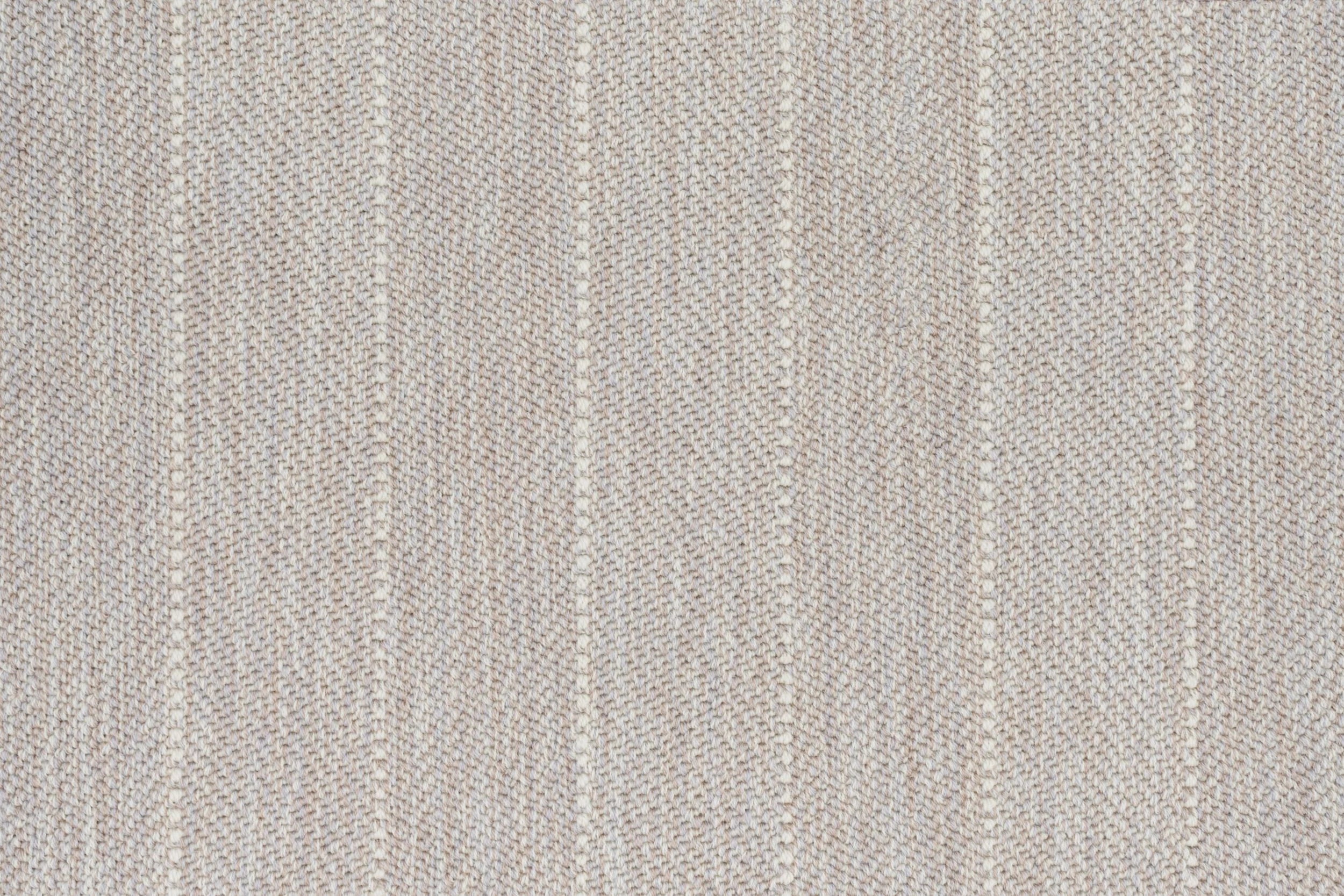 Broadloom carpet in a herringbone stripe pattern in cream.