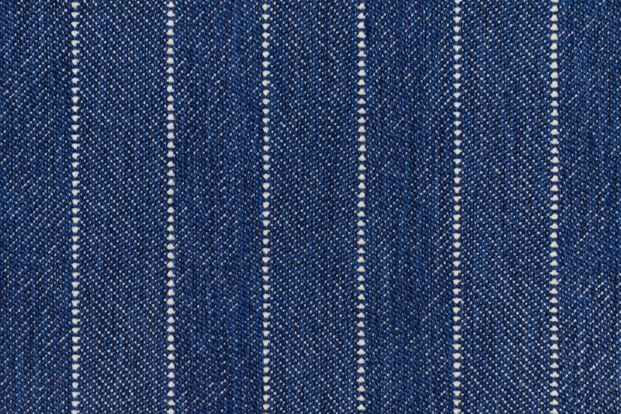 Broadloom carpet in a herringbone stripe pattern in royal blue.