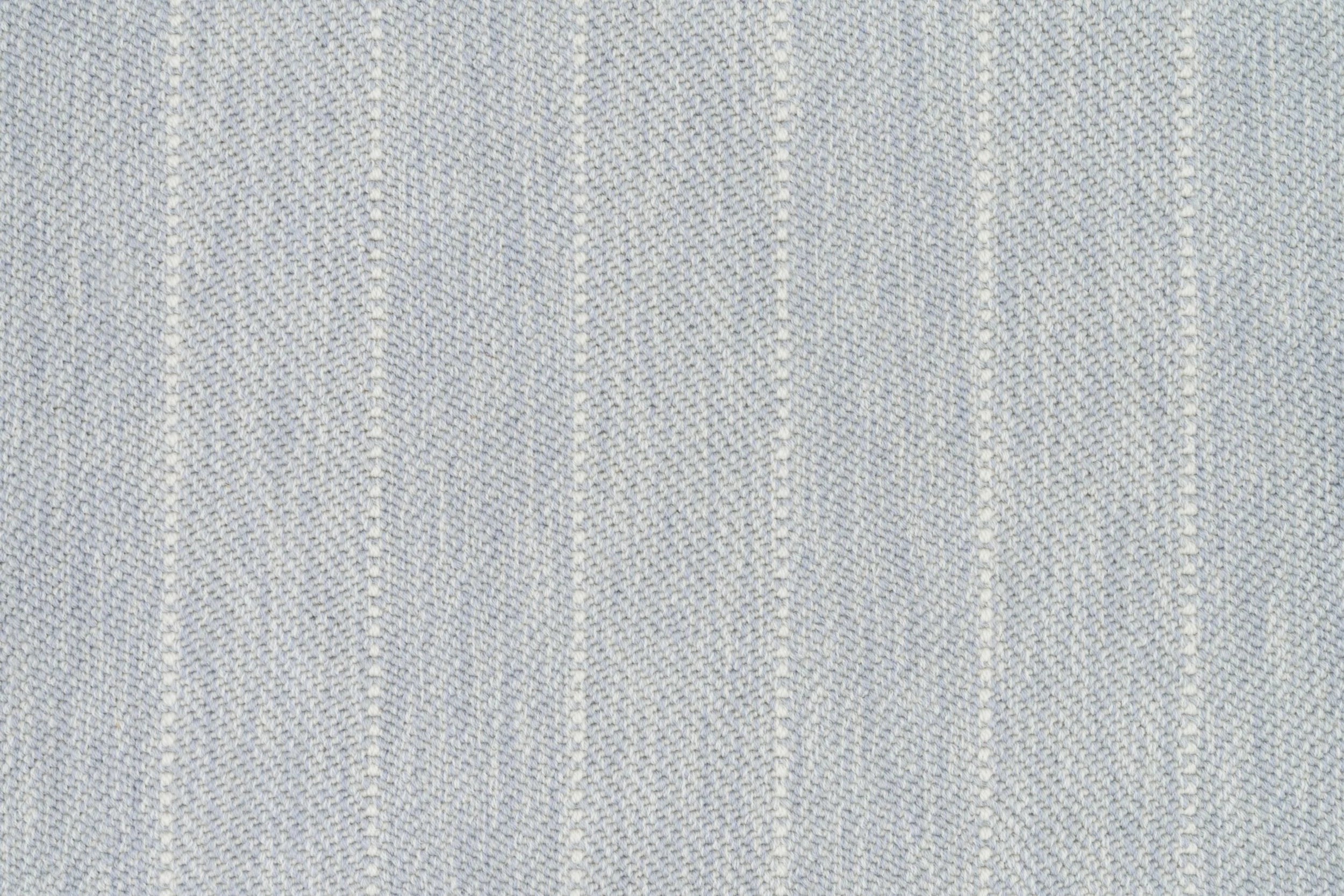 Broadloom carpet in a herringbone stripe pattern in pale blue.