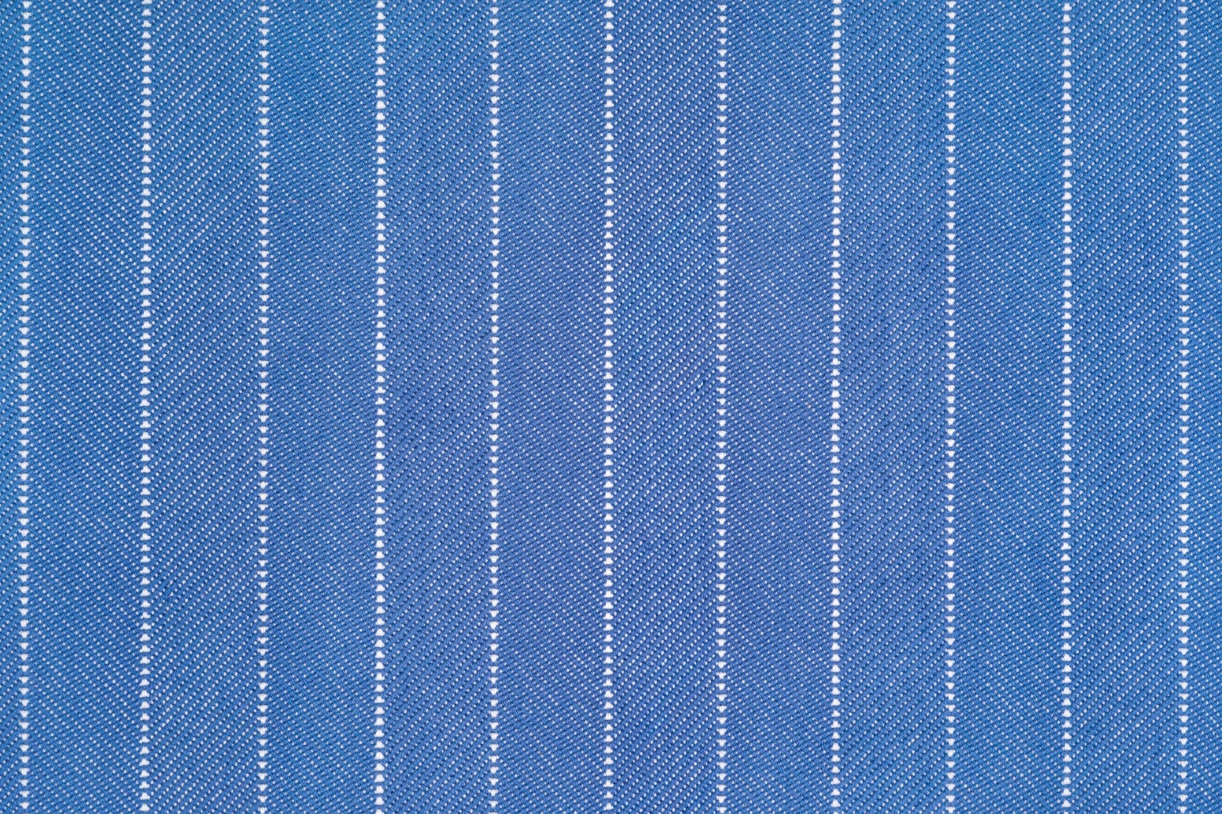 Broadloom carpet in a herringbone stripe pattern in blue.