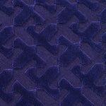 Close-up of a textured blue rug with geometric pattern