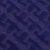 Close-up of a textured blue rug with geometric pattern