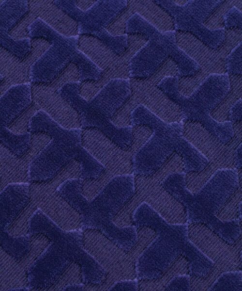 Close-up of a textured blue rug with geometric pattern
