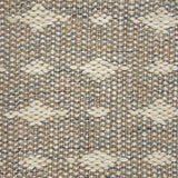 Handwoven rug detail in a contemporary spotted design in grey and beige