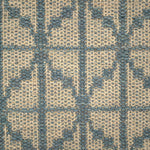 Handwoven rug detail in a diamond design in blue and beige