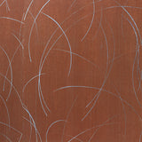 Detail of a wallpaper in an elongated paint splatter pattern in metallic silver on a rust field.