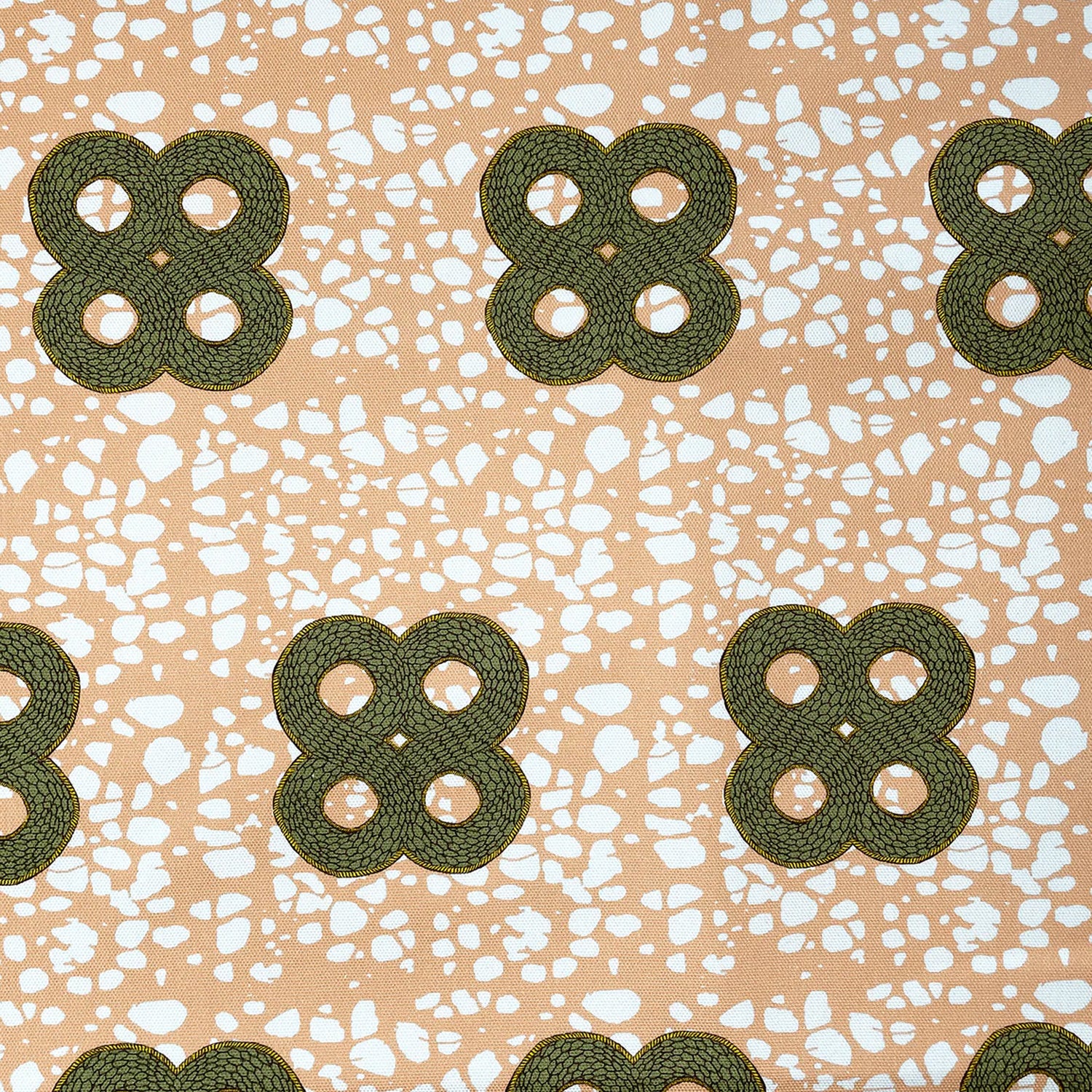 Detail of fabric in a curvilinear print in green and brown on a mottled coral field.