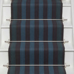 Striped flatweave runner in blue and black on white staircase