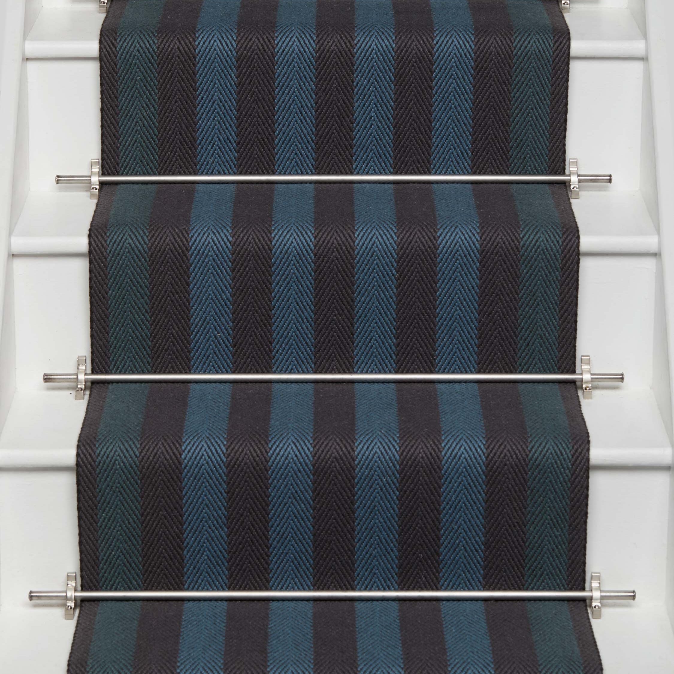 Striped flatweave runner in blue and black on white staircase