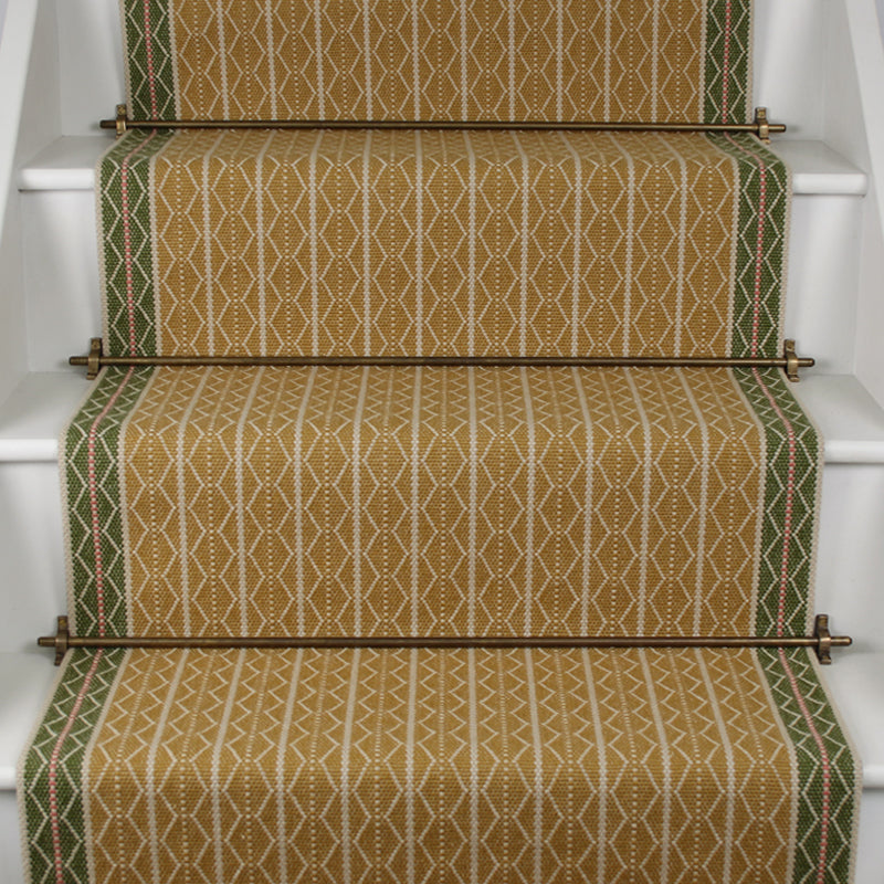 Striped flatweave runner in green and mustard on white staircase