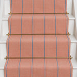 Striped flatweave runner in pink and blue on white staircase