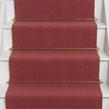 Striped flatweave runner in red and orange on white staircase