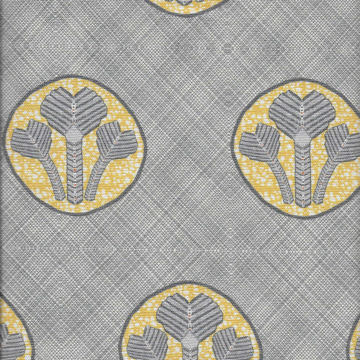Detail of fabric in a repeating curvilinear floral print in yellow and gray on a gray field.