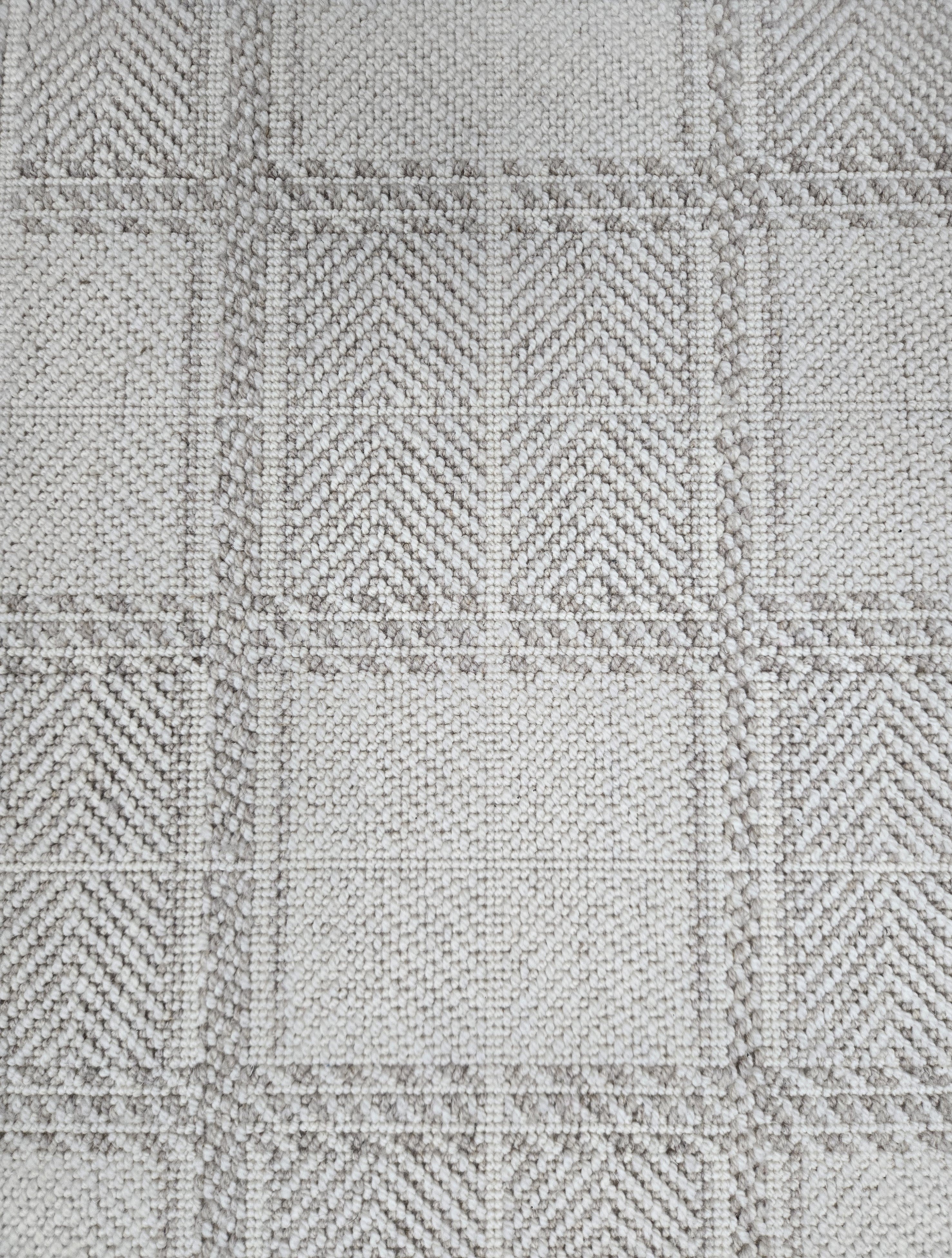 Broadloom carpet in wide box checkerboard pattern in cream and grey.