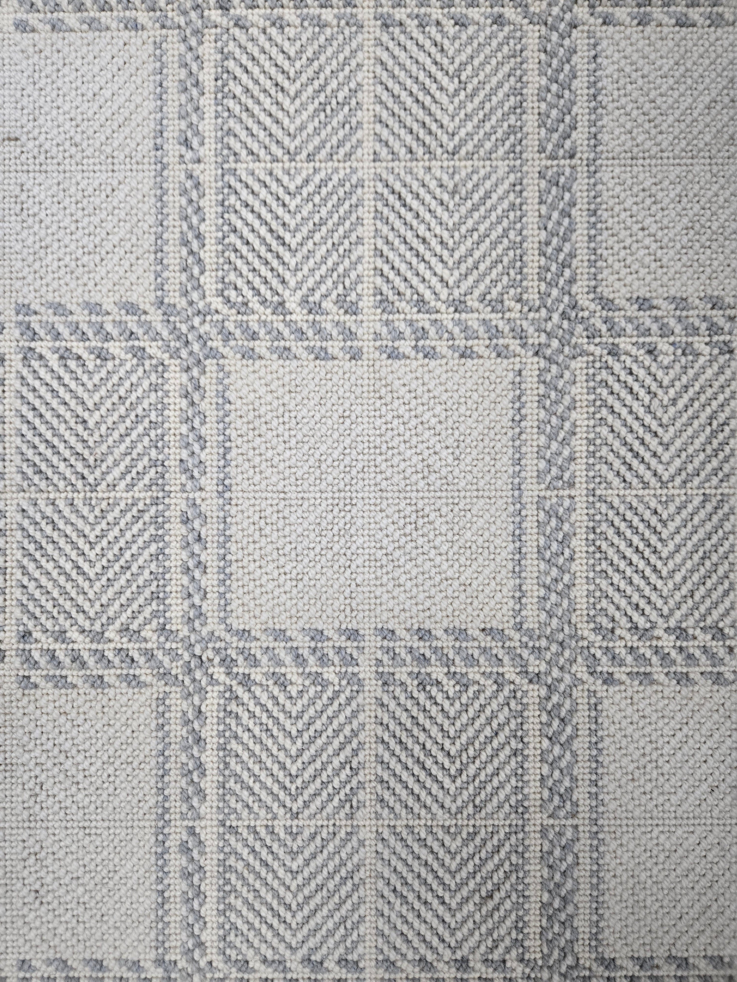Broadloom carpet in wide box checkerboard pattern in cream and light blue.