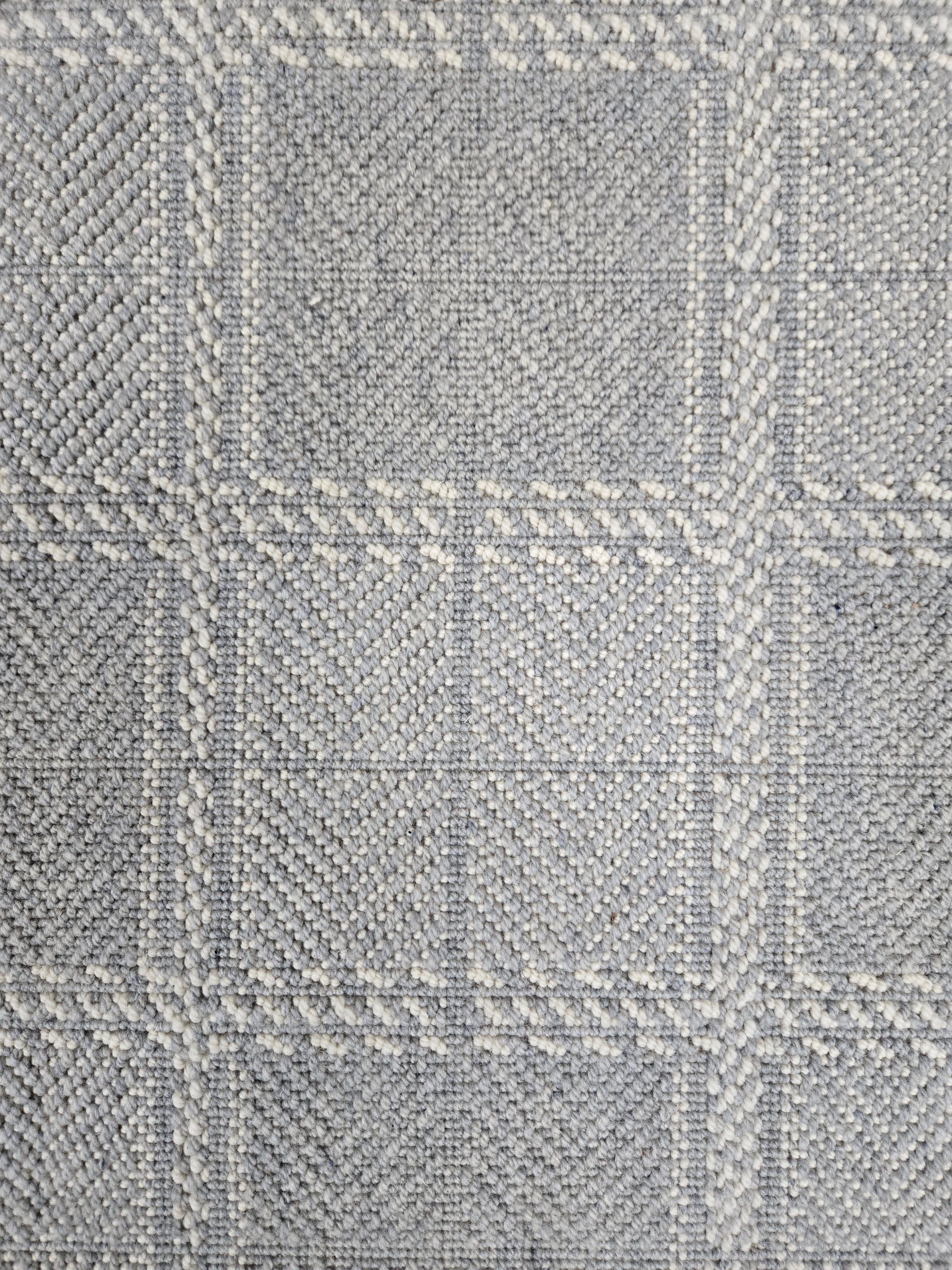 Broadloom carpet in wide box checkerboard pattern in cream and light blue.