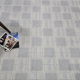 Gray checkered carpet with a magazine on top