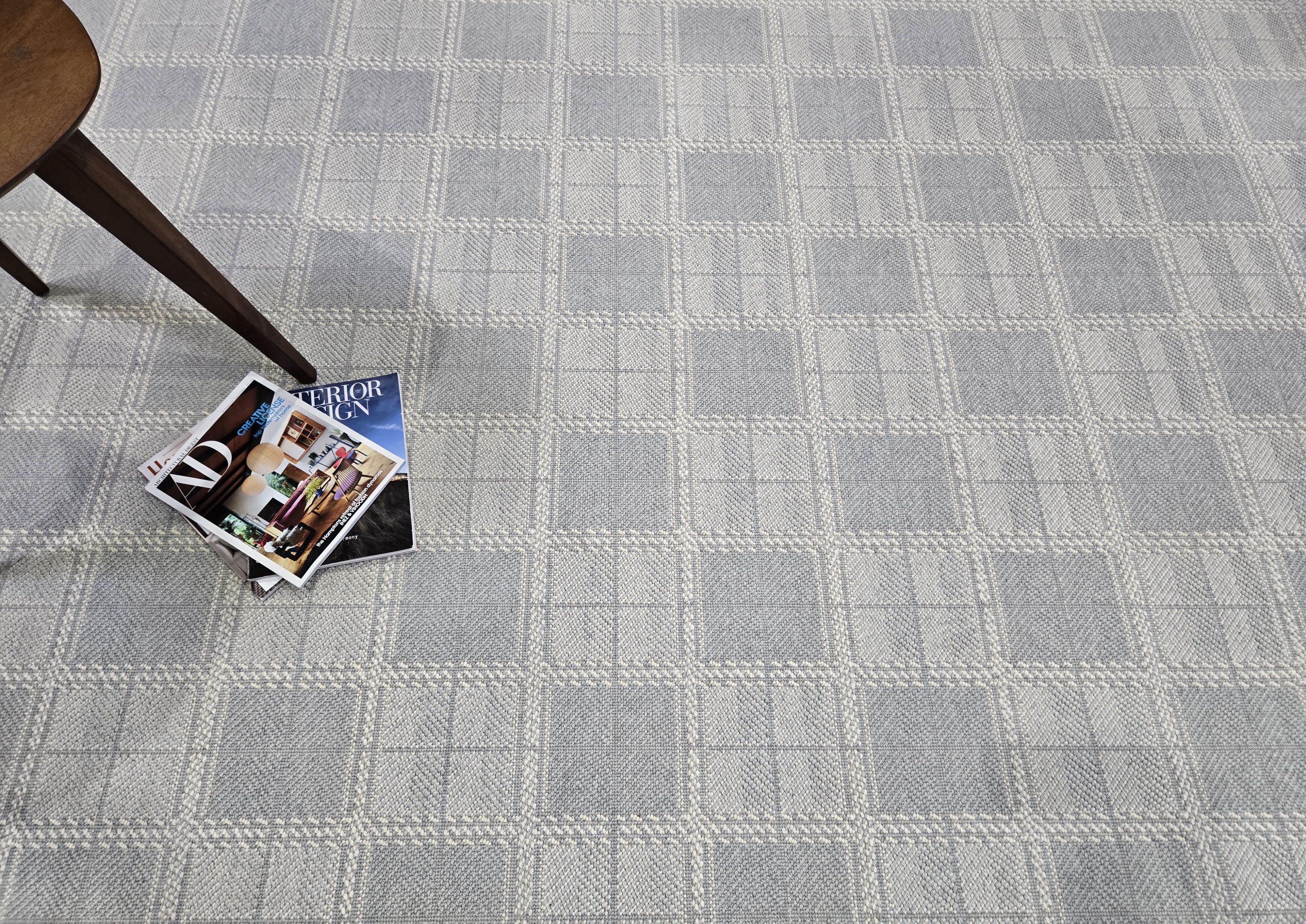 Gray checkered carpet with a magazine on top