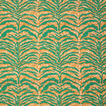 Detail of fabric in a linear botanical print in green on a mottled cream and orange field.