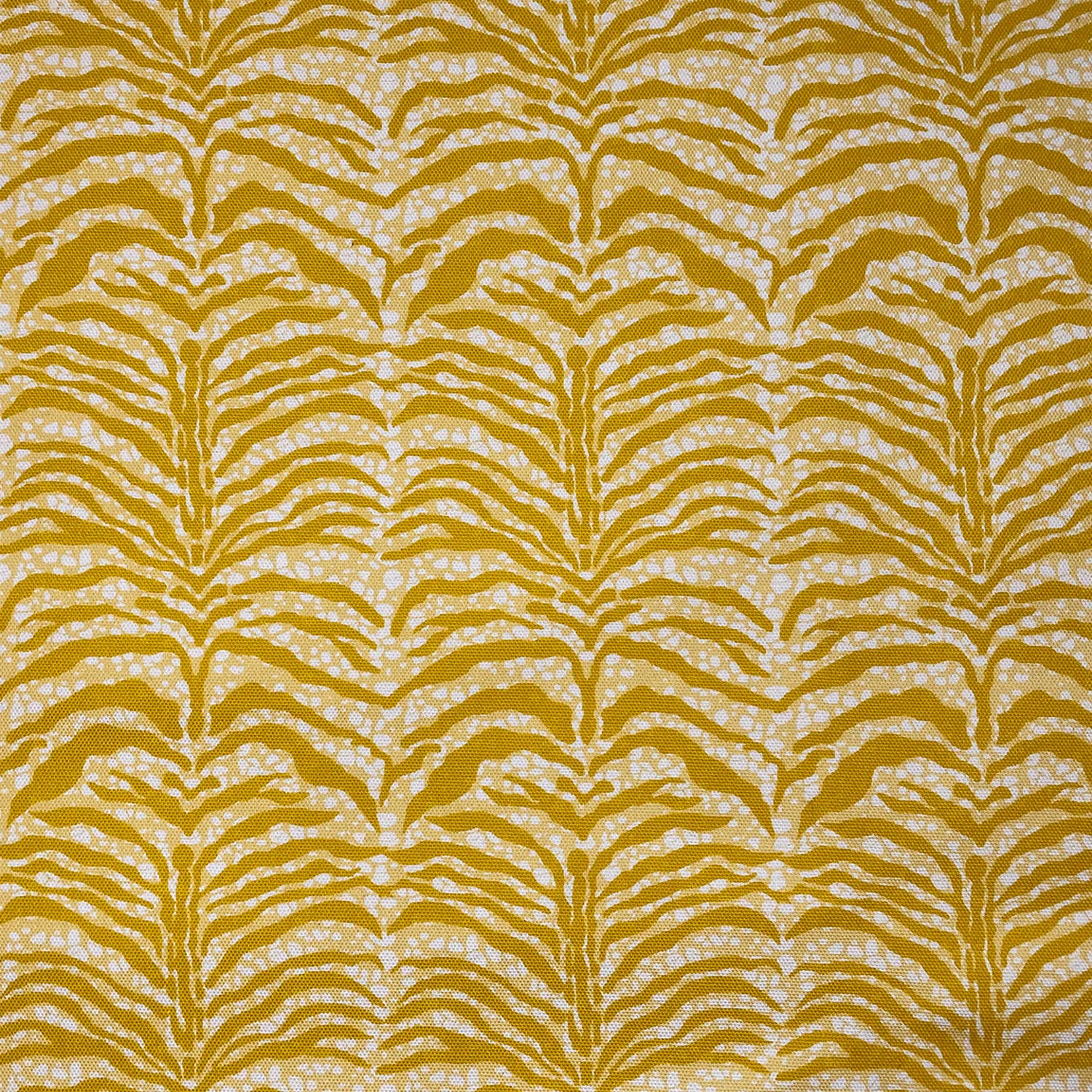 Detail of fabric in a linear botanical print in mustard on a mottled yellow and cream field.