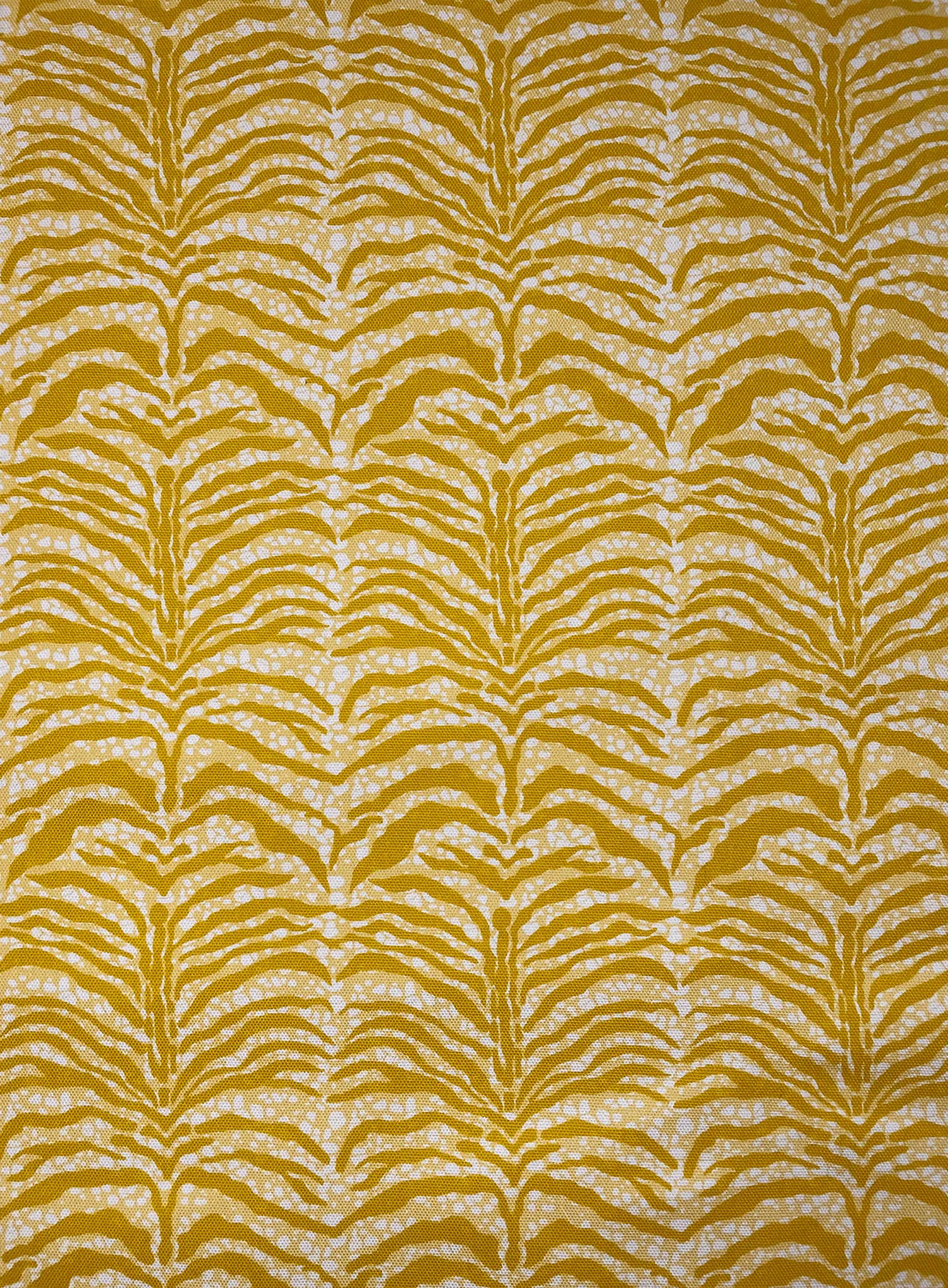 Detail of fabric in a linear botanical print in mustard on a mottled yellow and cream field.