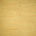 Detail of fabric in an abstract embroidered pattern in red, yellow and blue on a yellow field.