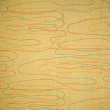 Detail of fabric in an abstract embroidered pattern in red, yellow and blue on a yellow field.