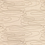 Detail of fabric in an abstract embroidered pattern in tan on a cream field.