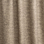 Draped fabric yardage in a textural geometric print in shades of brown on a brown field.