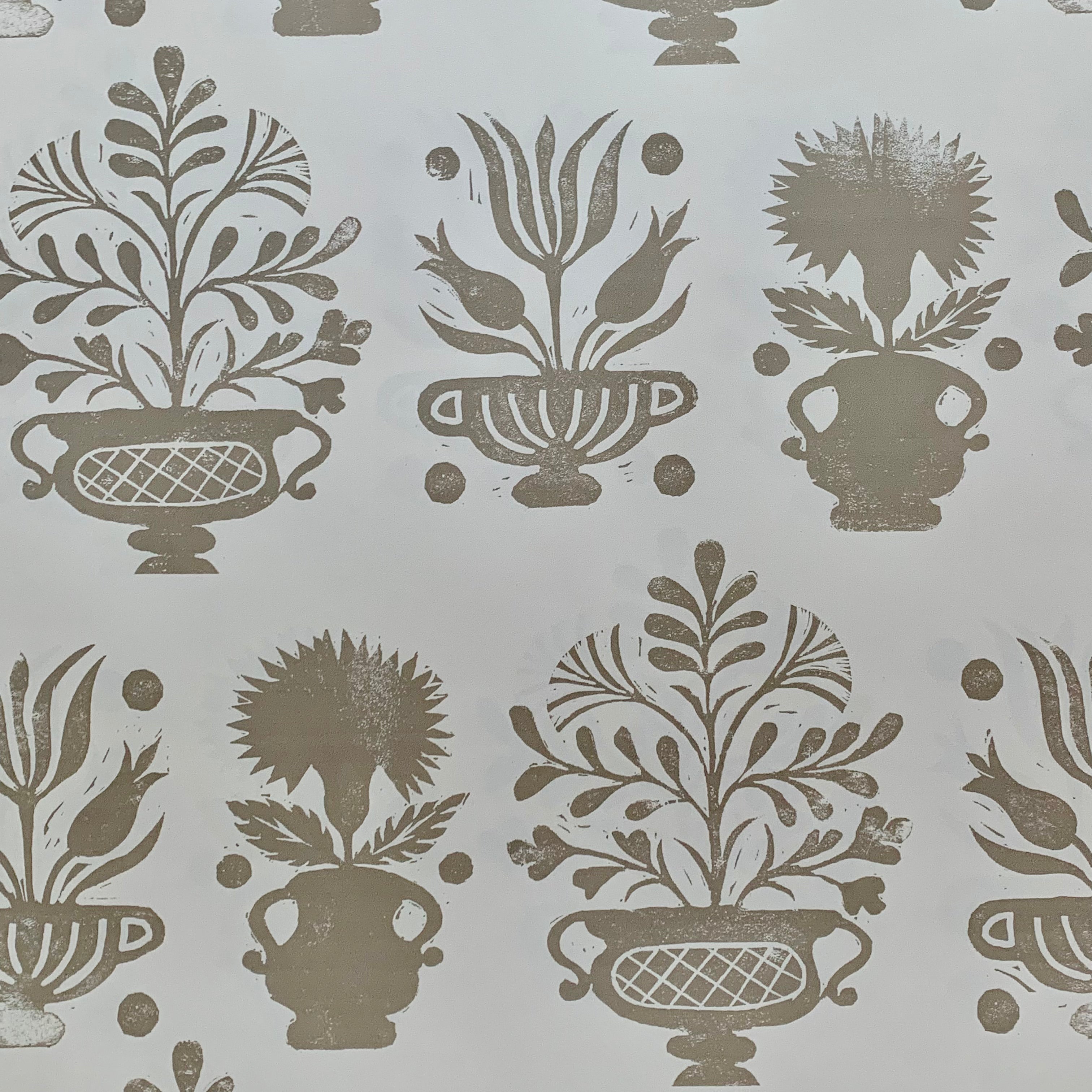 Detail of wallpaper in a repeating vase and plant print in gray on a white field.