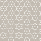 Fabric in a floral lattice print in white on a greige field.