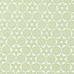 Fabric in a floral lattice print in white on a light green field.