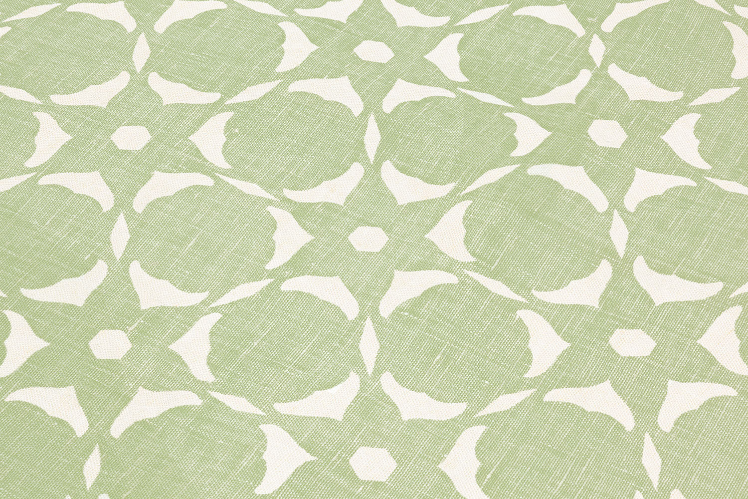 Fabric yardage in a floral lattice print in white on a light green field.