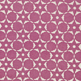 Detail of a floral lattice print in cream on a magenta field.