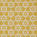 Fabric in a floral lattice print in white on a mustard field.