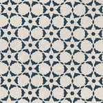 Fabric in a floral lattice print in navy on a cream field.