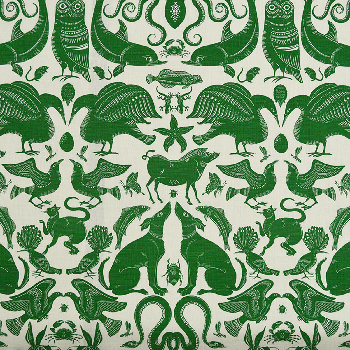 Patterned fabric with animals and sea creatures in green on a white background