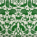 Patterned fabric with animals and sea creatures in green on a white background