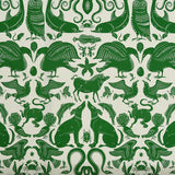 Patterned fabric with animals and sea creatures in green on a white background