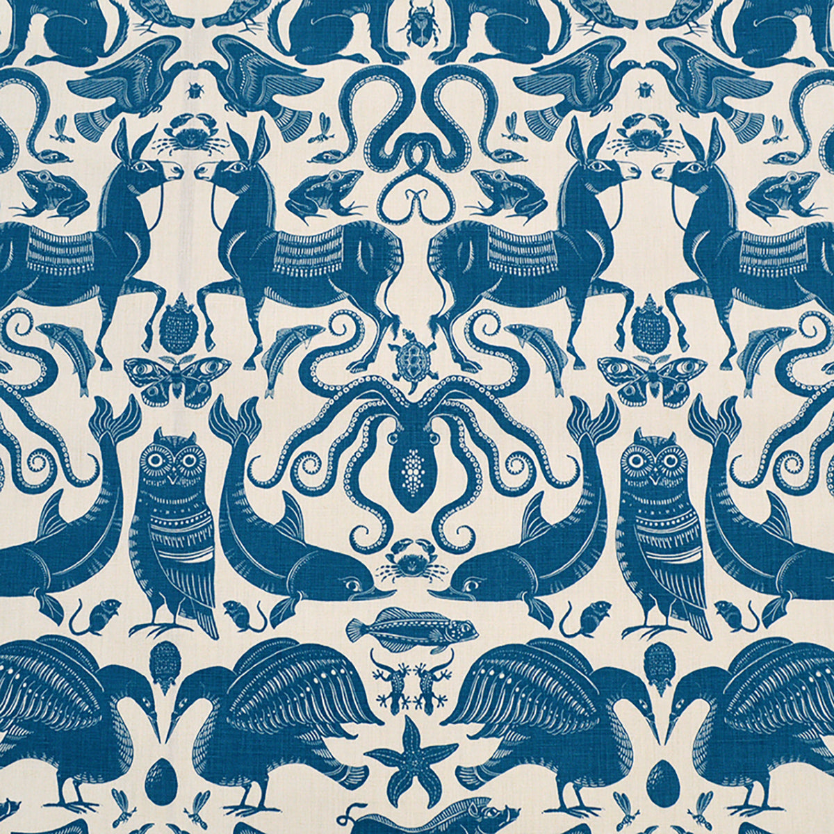 Patterned fabric with animals and sea creatures in blue on a white background
