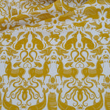 Draped patterned fabric with animals and sea creatures in yellow on a white background