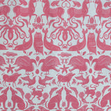 Patterned fabric with animals and sea creatures in pink on a white background