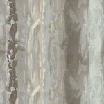 Detail of fabric in an abstract paint swatch print in shades of brown, gray and blue.