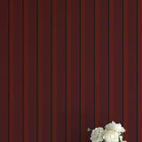 Vase with white flowers against a red striped background